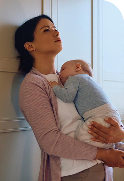 Mother holding child and contemplating her participation in the NORA520 Severe Postpartum Depression Clinical Research Study